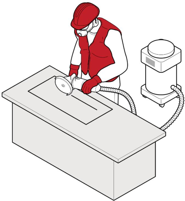A worker cutting/grinding with on tool dust extraction